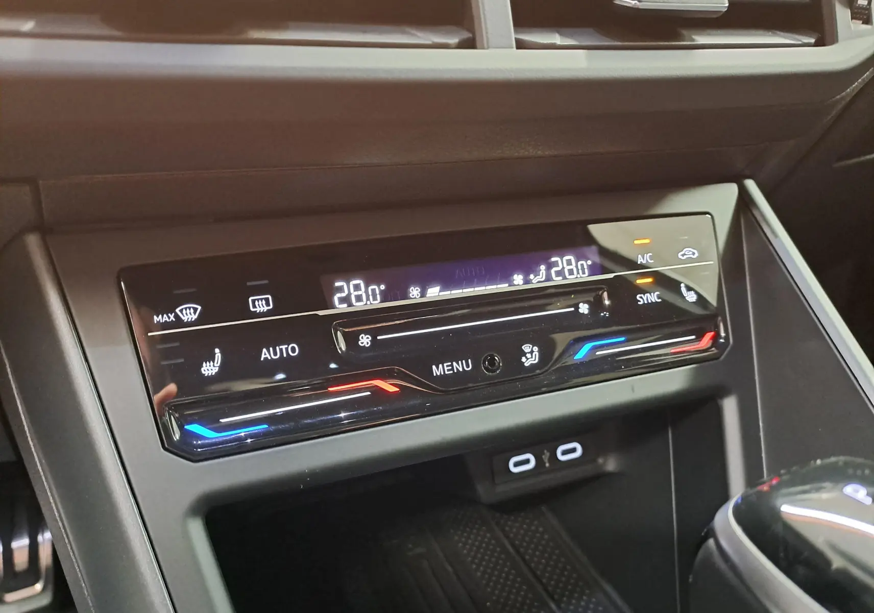 Gros plan sur la console centrale du Volkswagen Taigo 2025, affichant la climatisation automatique tactile bi-zone avec réglages numériques.
