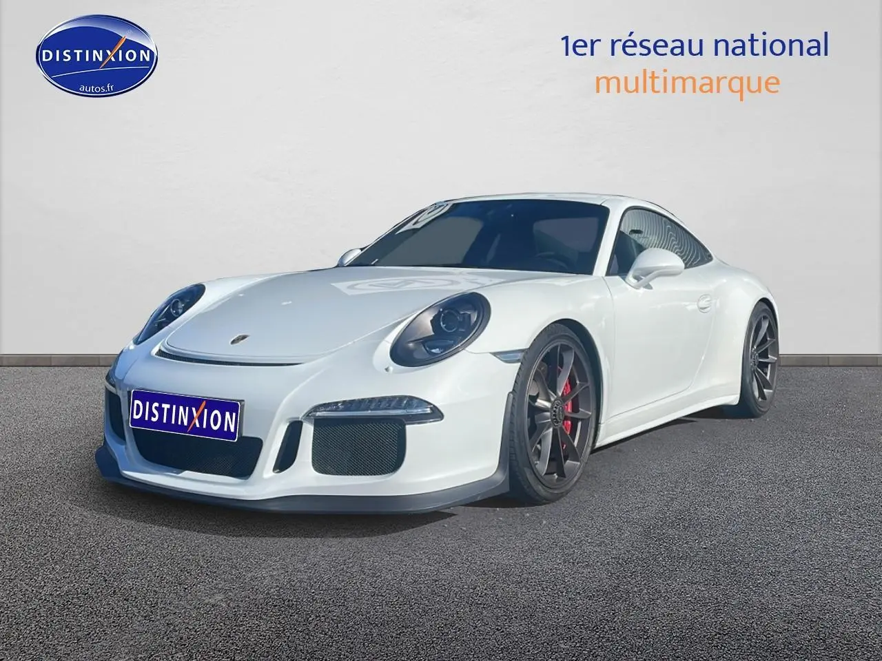 Porsche 911 (991) GT3 blanc vue 3/4 avant droit avec jantes foncées et étriers de frein rouges.