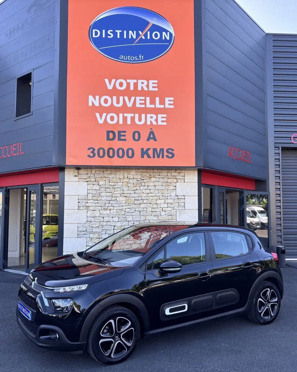 Citroën C3 PureTech 110 noir vue 3/4 avant droit, avec protections latérales blanches et jantes stylisées.