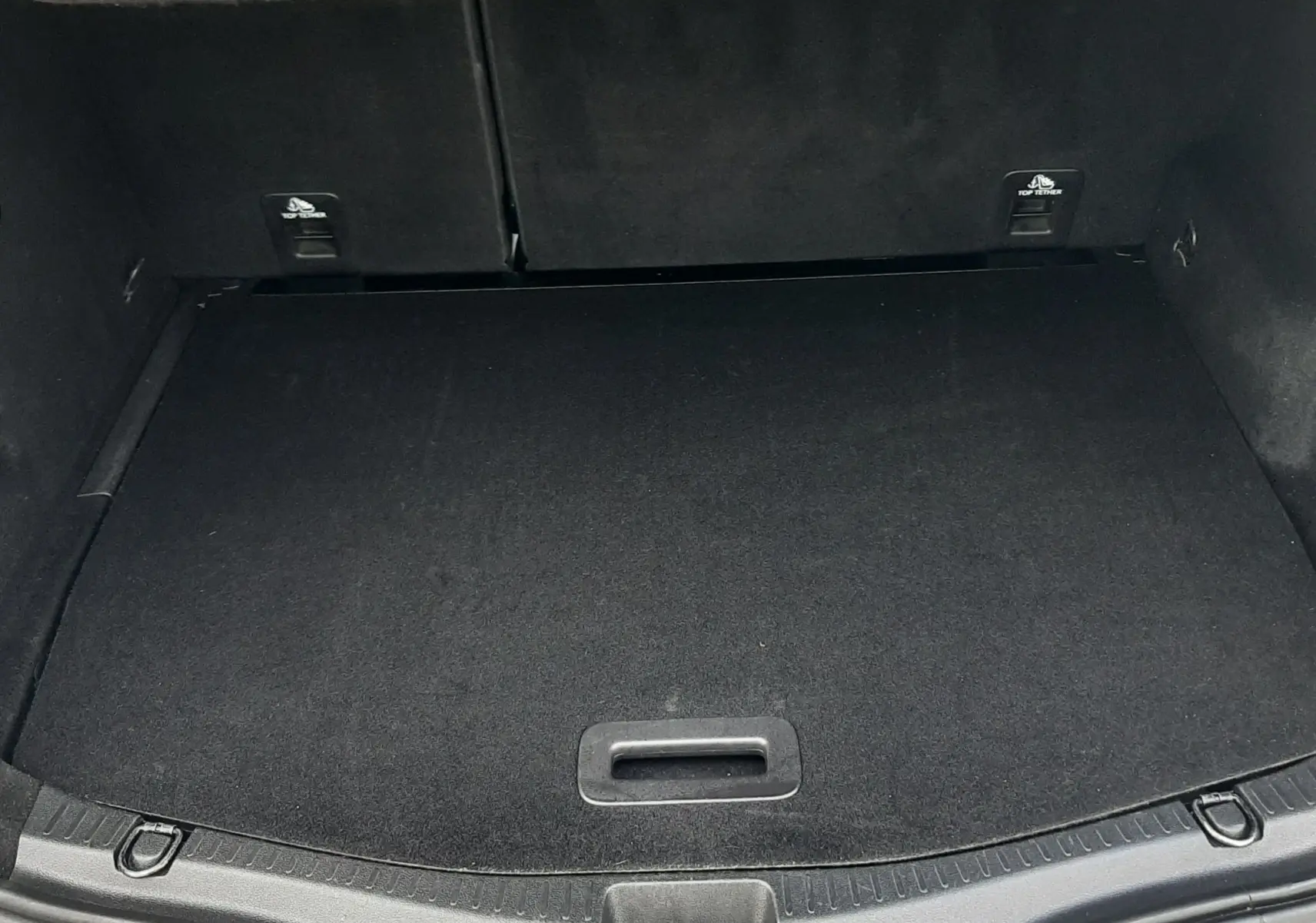 Gros plan sur l'attelage noir fixé au pare-chocs arrière gris cassiopée du Renault Scénic IV 1.7 Blue dCi 150ch Intens.