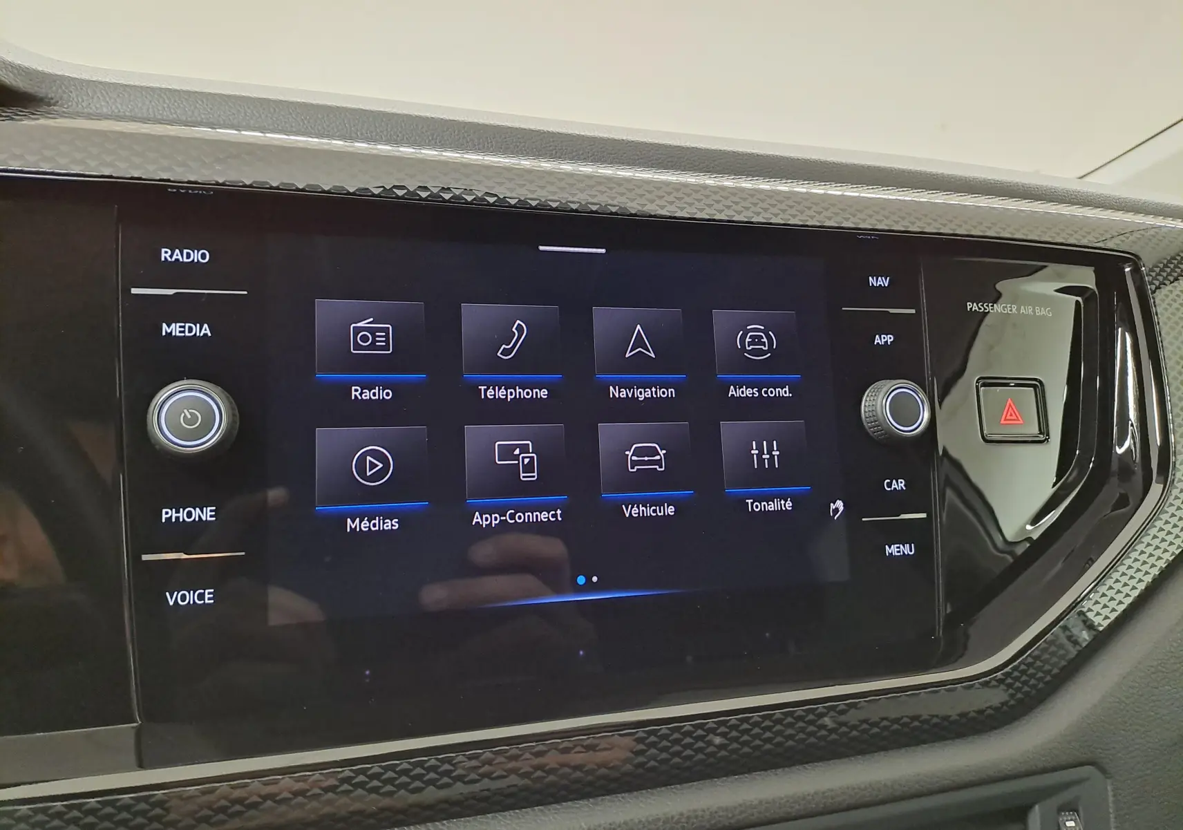 Écran tactile central du Volkswagen Taigo 2025, affichant les options radio, téléphone, navigation et aides à la conduite.