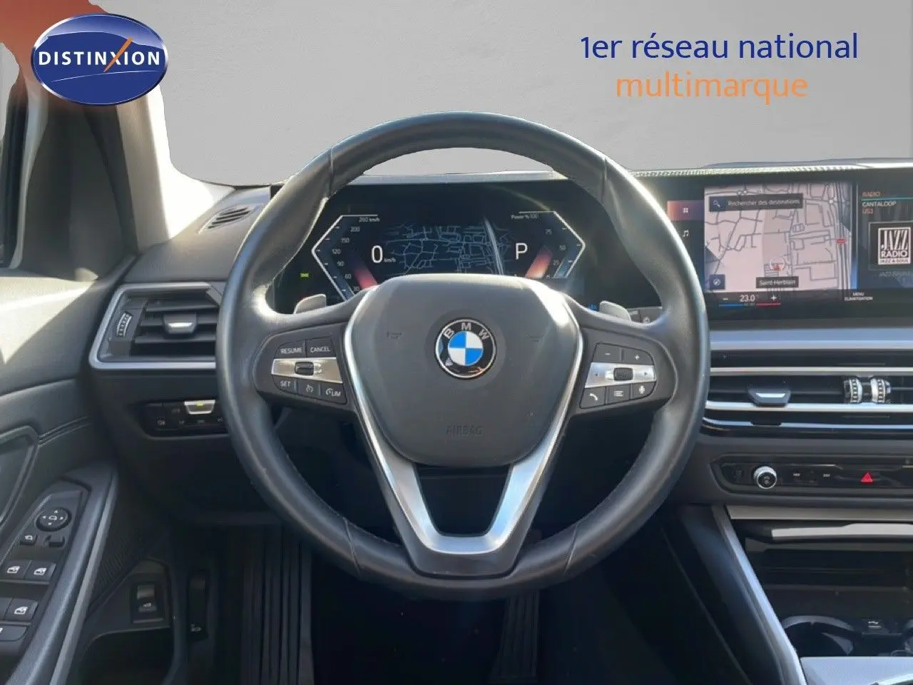 Vue intérieure centrée sur le volant cuir noir et le tableau de bord digital de la BMW Série 3 Touring F31 316d.
