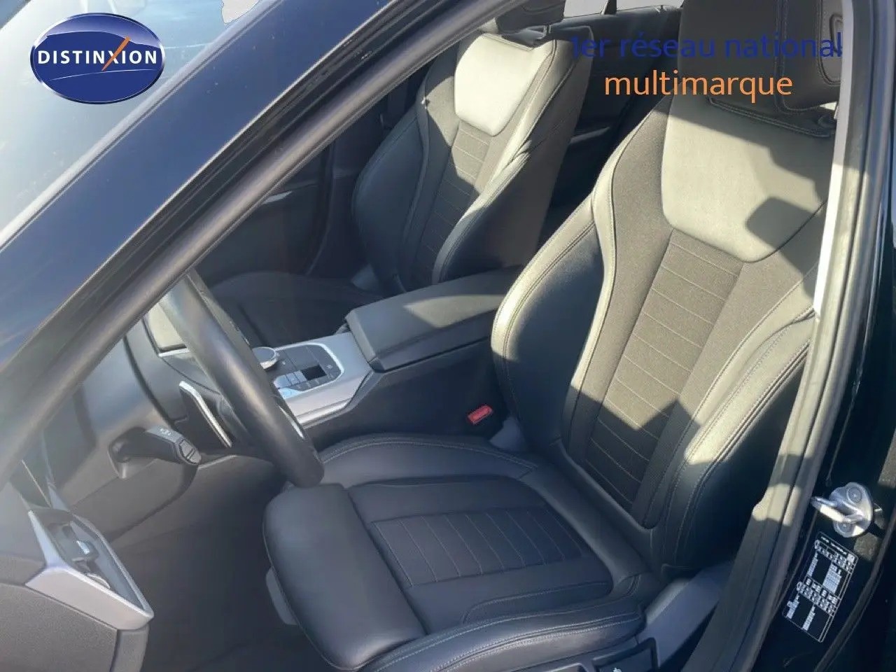 Vue intérieure côté conducteur d'une BMW Série 3 Touring F31 noire, sièges en cuir noir et console centrale moderne.