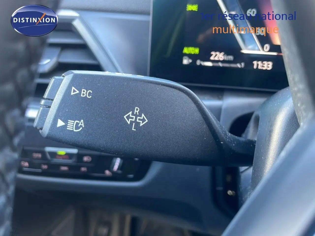 Gros plan sur la commande de clignotant gauche dans l’habitacle noir d’une BMW Série 3 Touring F31 316d 2022.