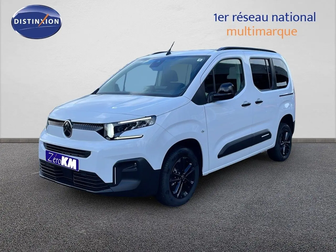 Vue 3/4 avant droite d'un Citroën Berlingo blanc glacier avec protections latérales noires et jantes noires.
