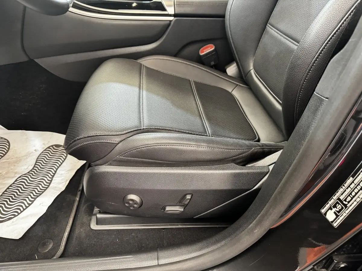 Gros plan sur le siège conducteur en cuir noir du Mercedes GLC 300 E Business Line 2023, vue côté gauche ouverte.