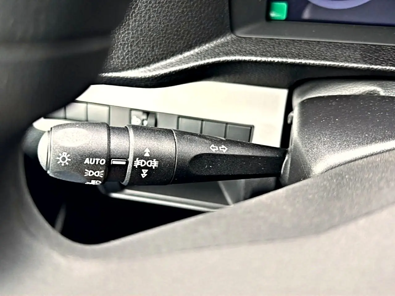 Gros plan sur la commande des phares et clignotants à gauche du volant dans un Fiat Scudo Combi gris titane 2026.