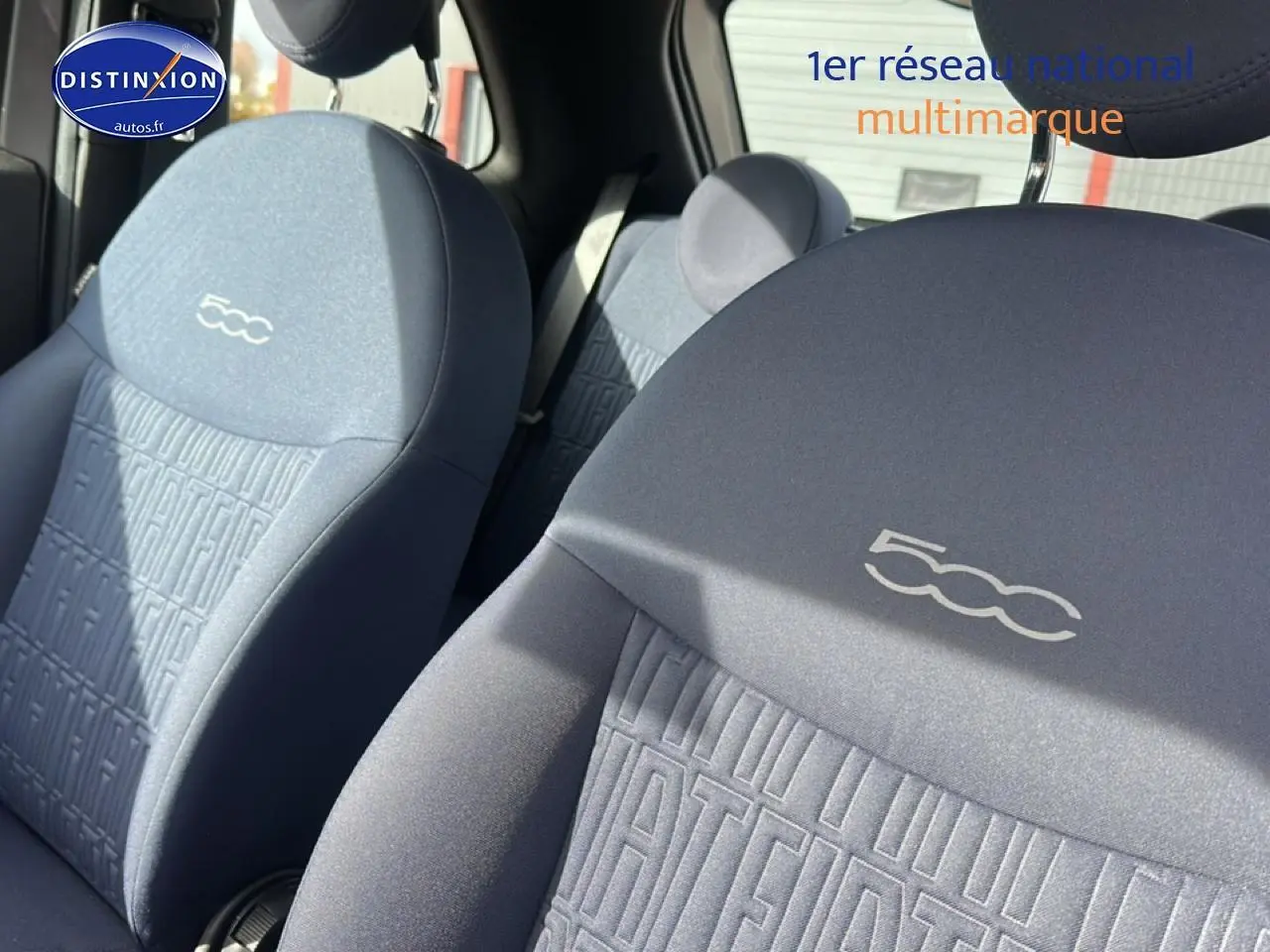 Gros plan sur les sièges avant gris de la FIAT 500 1.0 70 bsg cult, avec logo 500 brodé sur les appuie-têtes.