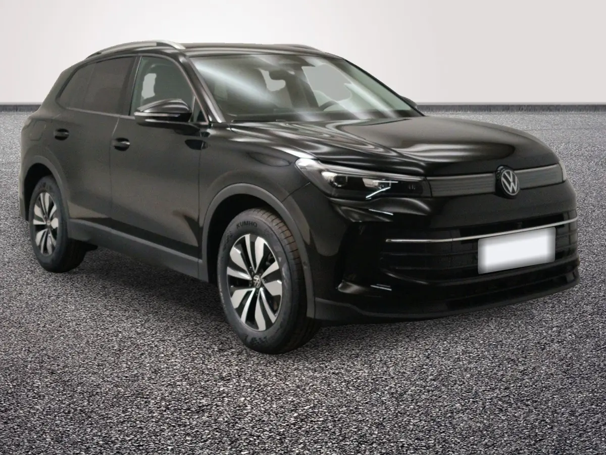 Volkswagen Tiguan noir vu 3/4 avant droit, avec jantes distinctives et calandre épurée.