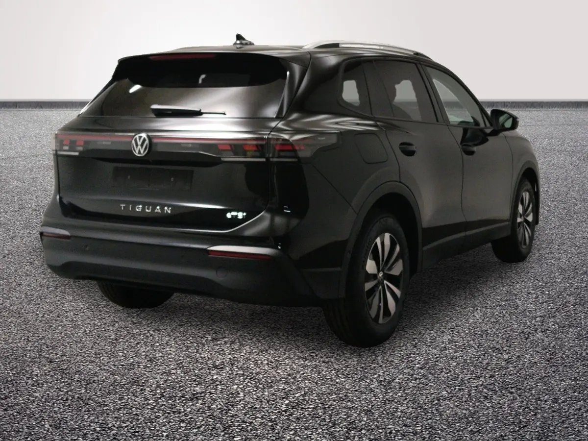 Vue 3/4 arrière droite d'un Volkswagen Tiguan noir avec feux arrière LED et jantes modernes.