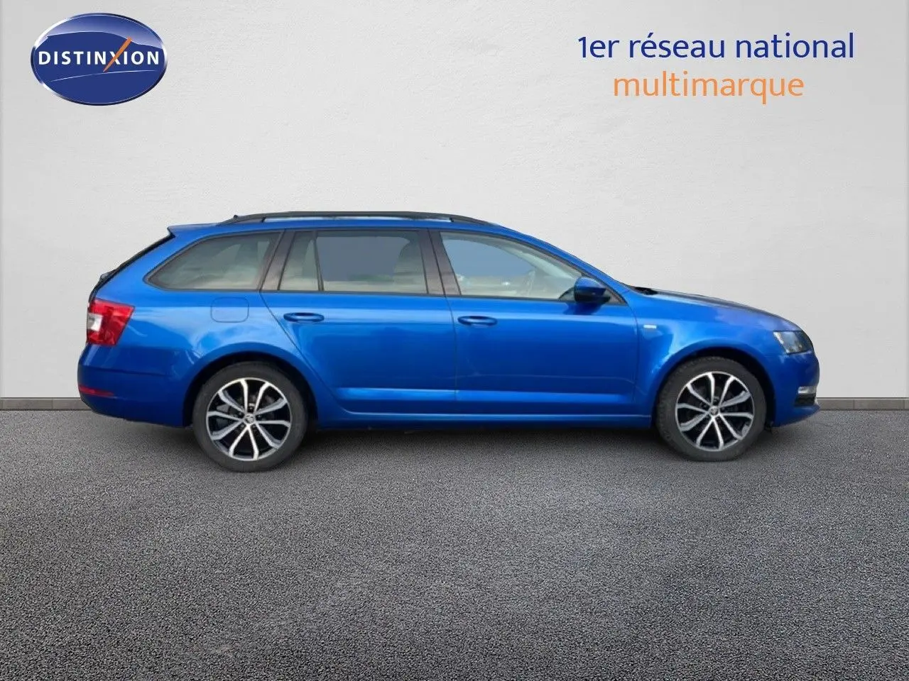 Profil latéral droit d'une Skoda Octavia Combi 2019 en bleu racing metal avec jantes alliage bicolores.