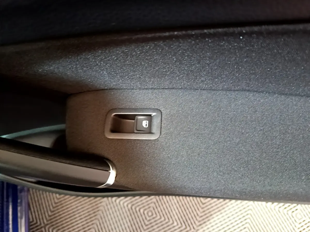Bouton de verrouillage des portes sur la portière côté gauche d'un Volkswagen Touran bleu 2021.