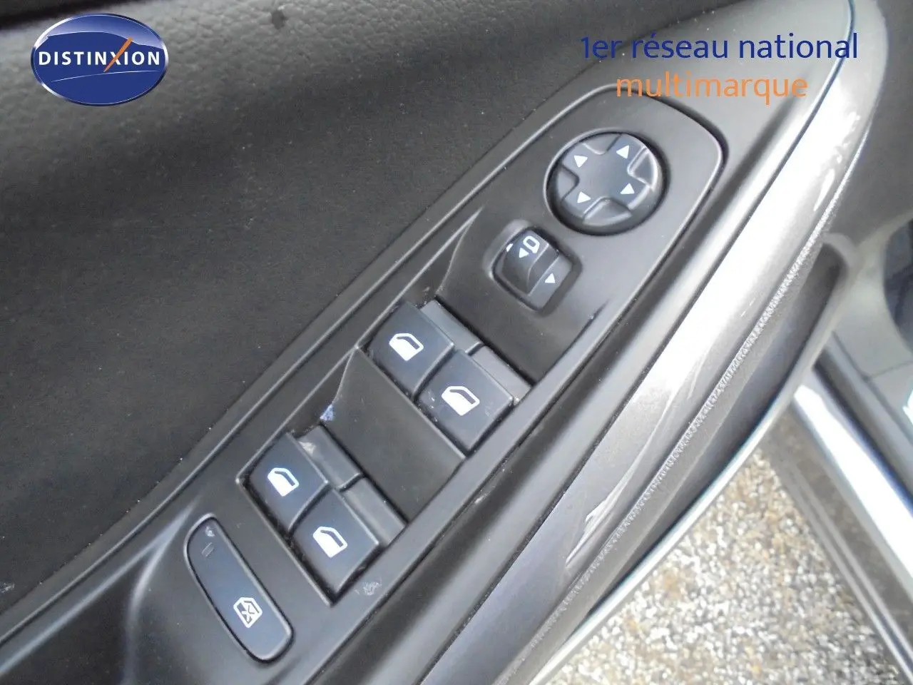 Gros plan sur les commandes des vitres et rétroviseurs côté conducteur d’un Opel Grandland X gris Moai Metal.