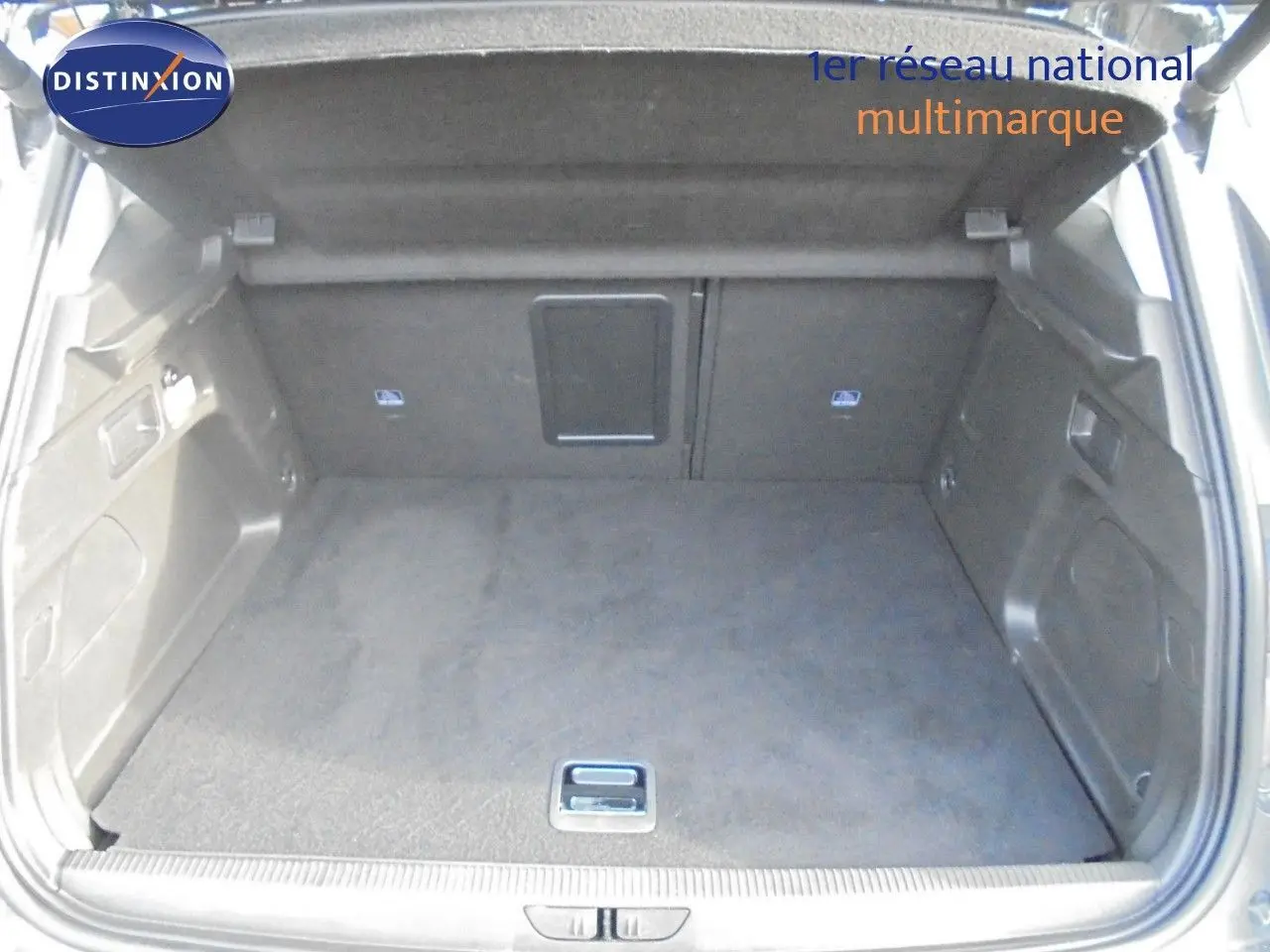 Coffre ouvert en vue arrière d'un Opel Grandland X gris Moai Metal, montrant un espace de chargement propre et spacieux.