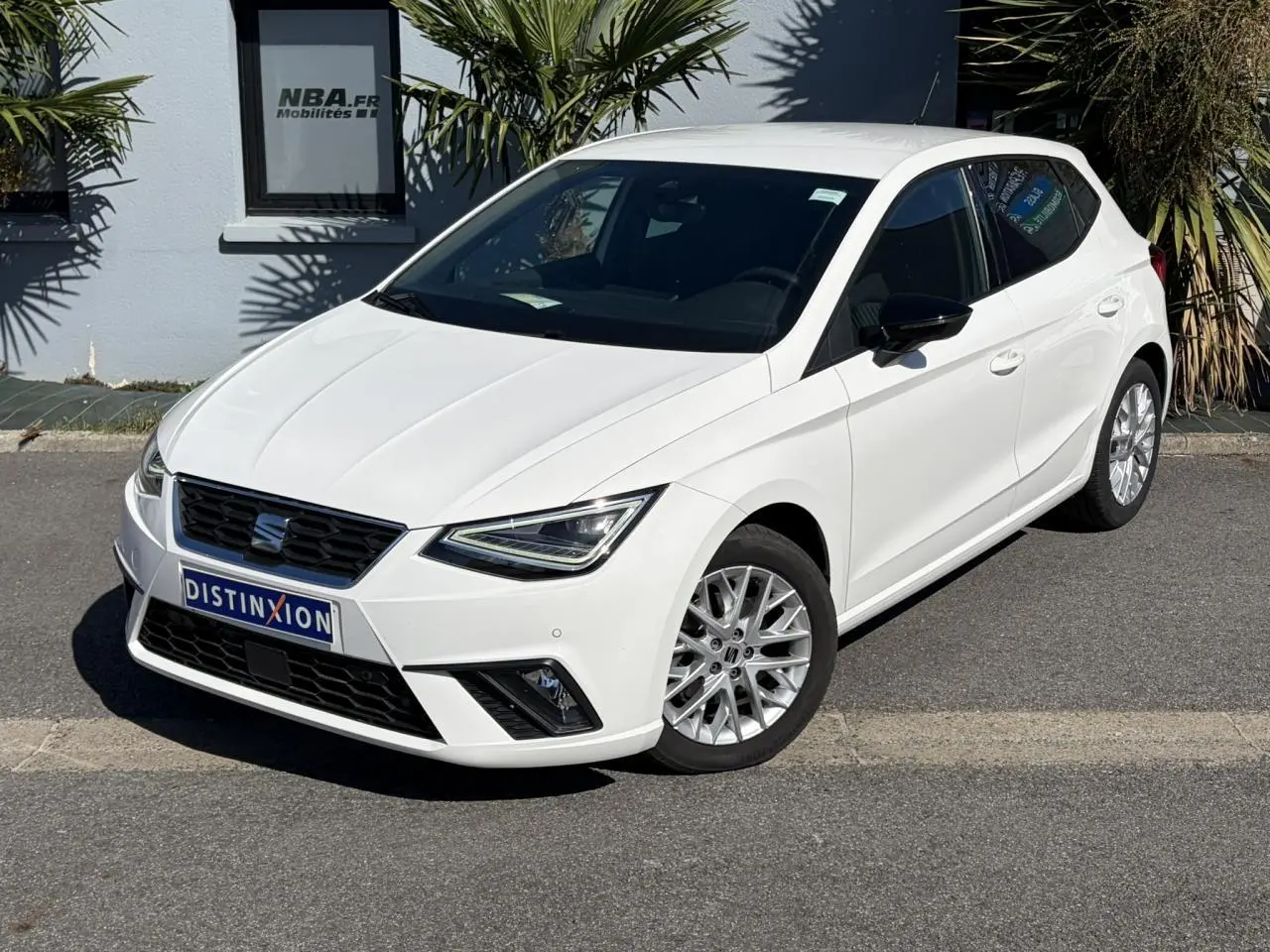 SEAT Ibiza TSI 115 FR blanc Candy vue 3/4 avant droit, jantes alliage et feux LED triangulaires visibles.