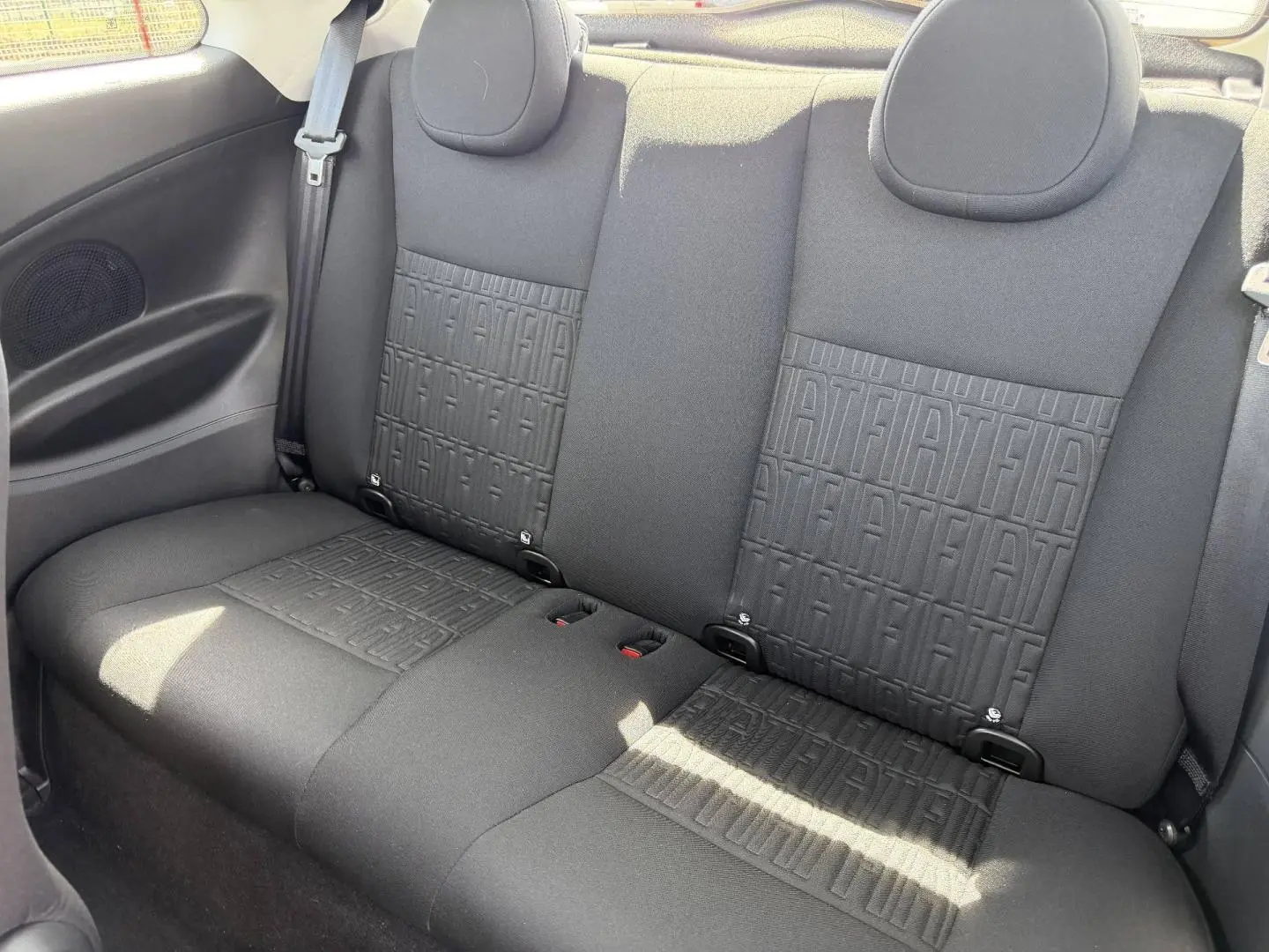 Vue intérieure de la banquette arrière noire avec motif monogramme Fiat du Fiat 500 e 118ch MY23.