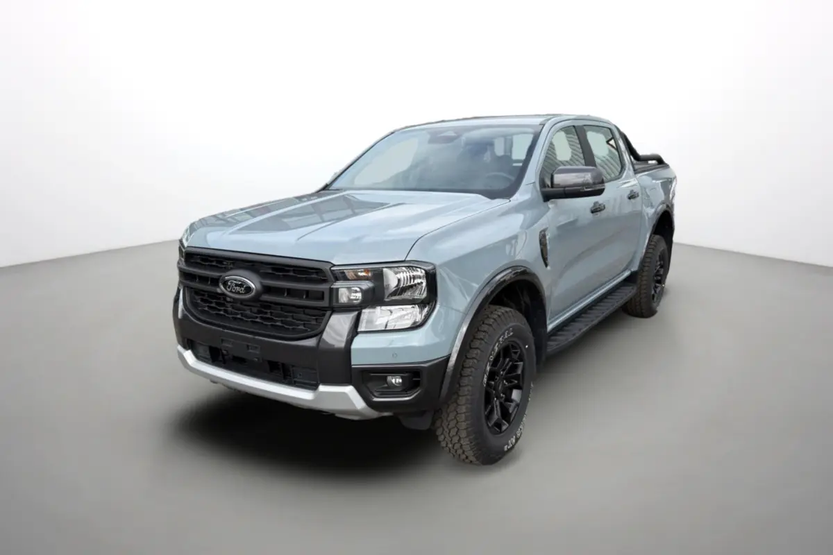 Ford Ranger gris commandeur en 3/4 avant droit avec arceaux noirs et marchepieds visibles.