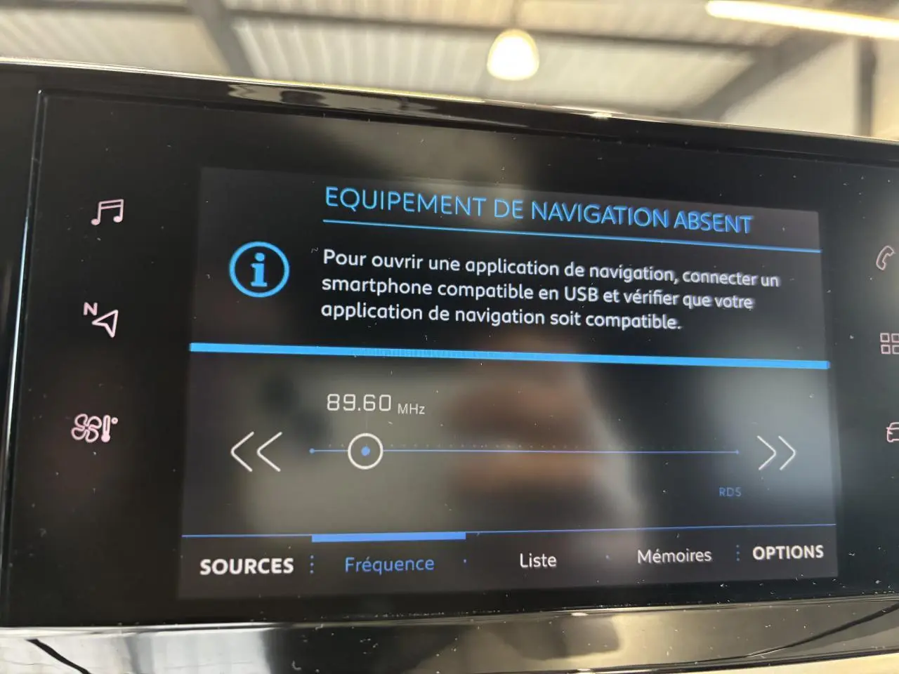 Écran tactile intérieur de la Peugeot 208 blanche affichant un message d'absence de navigation.