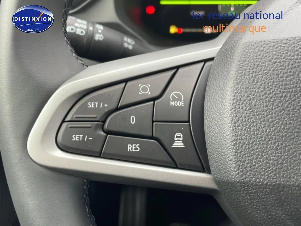 Gros plan sur les commandes noires du volant en cuir du Dacia Bigster 2025, côté gauche, avec boutons de régulateur et mode.