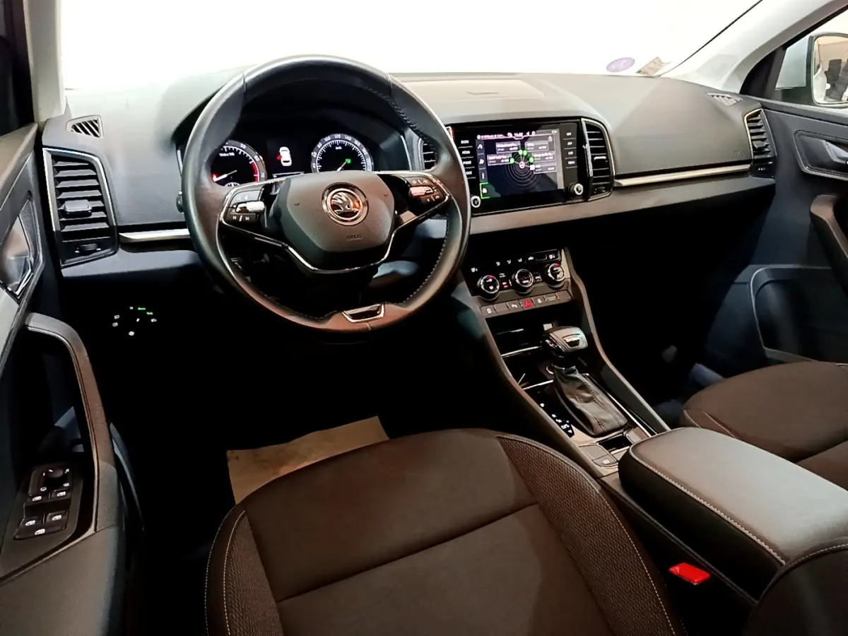 Vue intérieure du poste de conduite du Skoda Karoq 2022, avec tableau de bord numérique et écran tactile central.