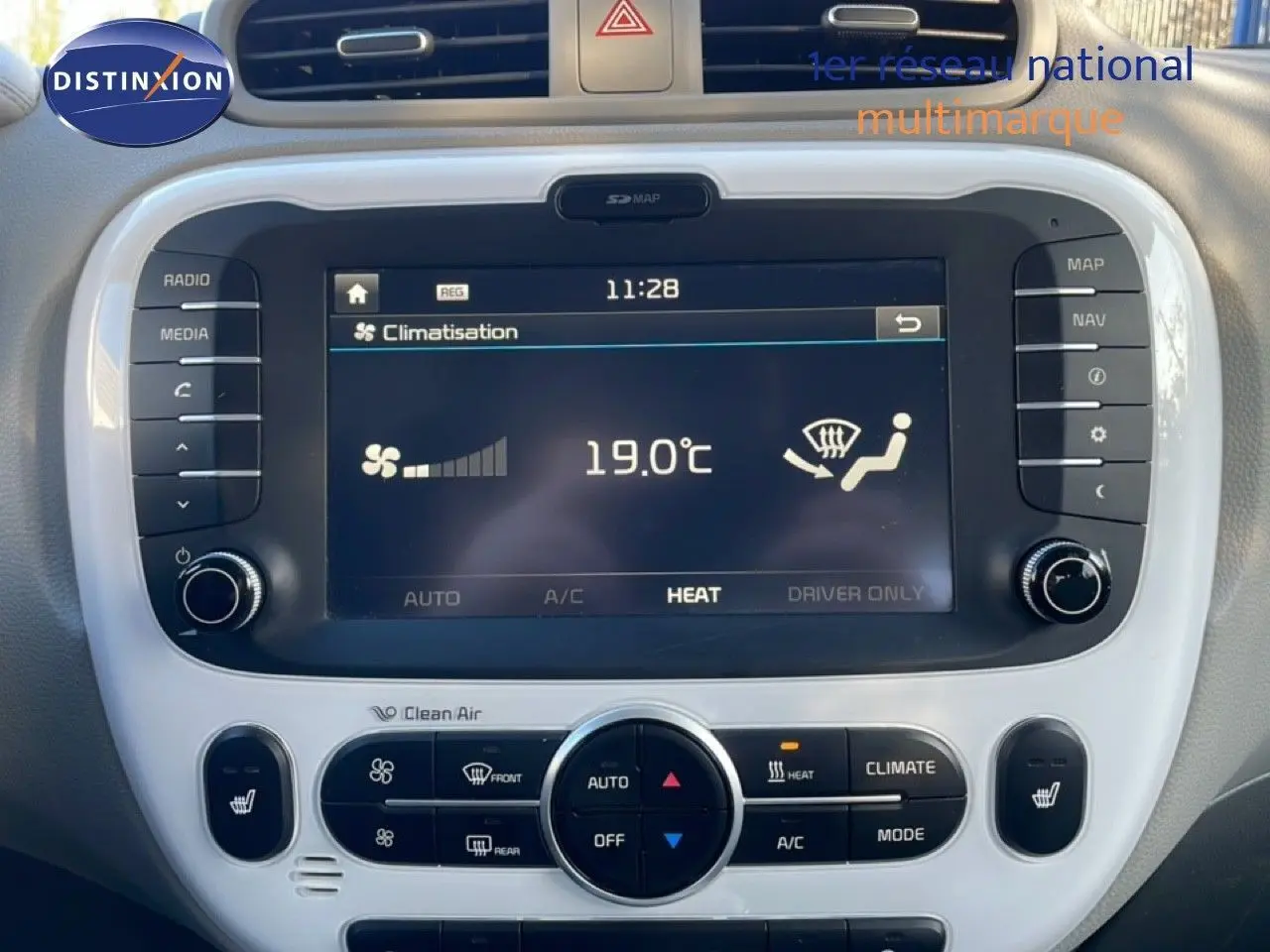 Vue rapprochée du tableau de bord du Kia Soul EV 2016, écran tactile affichant la climatisation à 19°C, entouré de commandes.