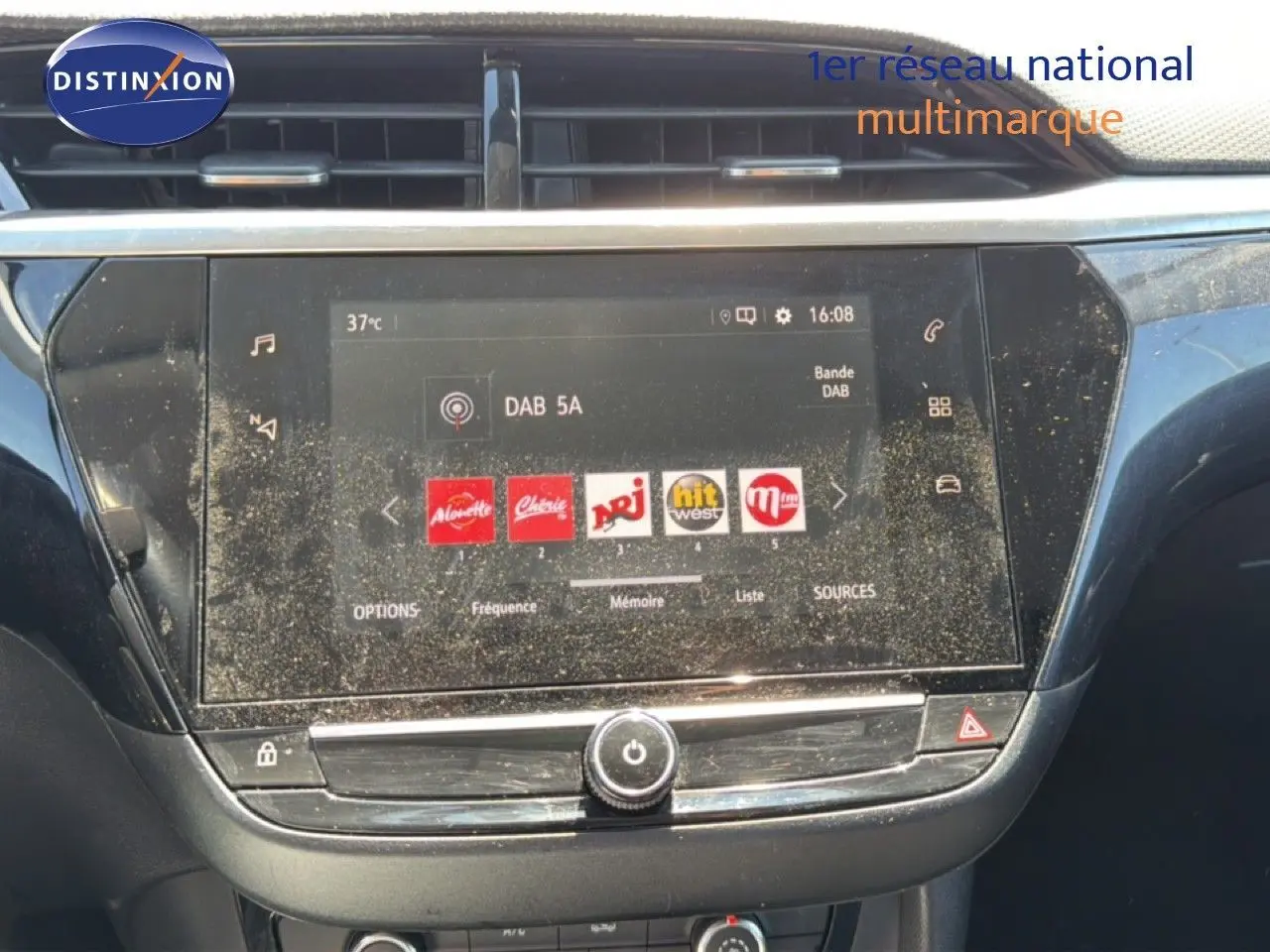 Vue rapprochée de l’écran tactile central de l’Opel Corsa gris quartz métal, affichant les stations radio DAB.