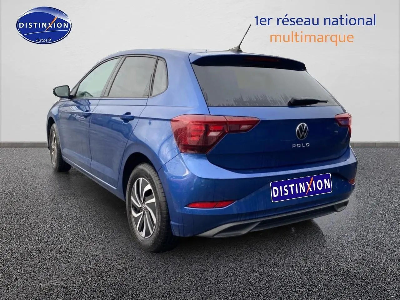 Vue 3/4 arrière gauche d'une Volkswagen Polo 1.0 TSI 95 VW Edition bleu récif avec jantes alliage et vitres surteintées.