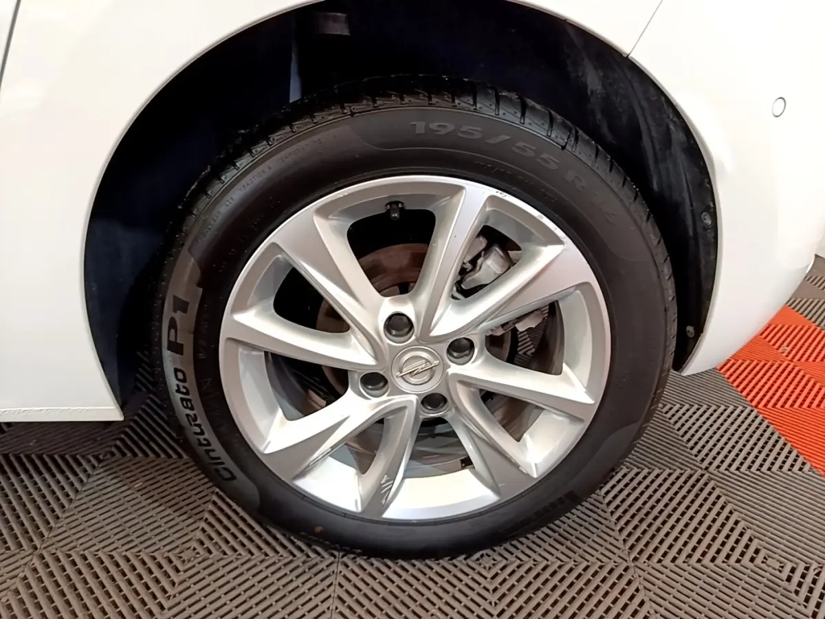 Gros plan sur la roue avant droite de l’Opel Corsa blanche, mettant en valeur la jante alliage et le pneu Pirelli.