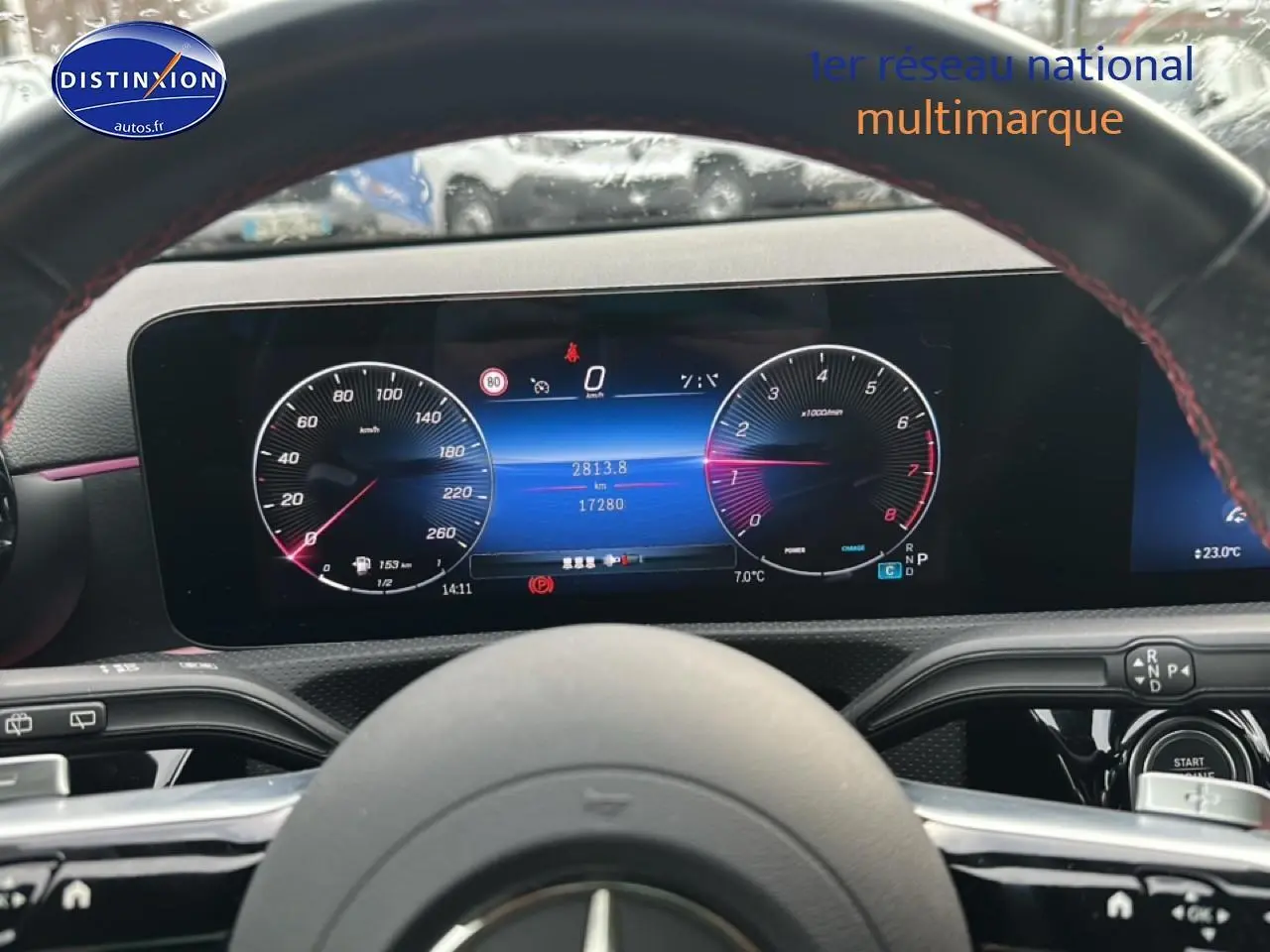 Vue intérieure centrée sur le tableau de bord numérique et le volant cuir de la Mercedes Classe A 180 AMG Line bleu.