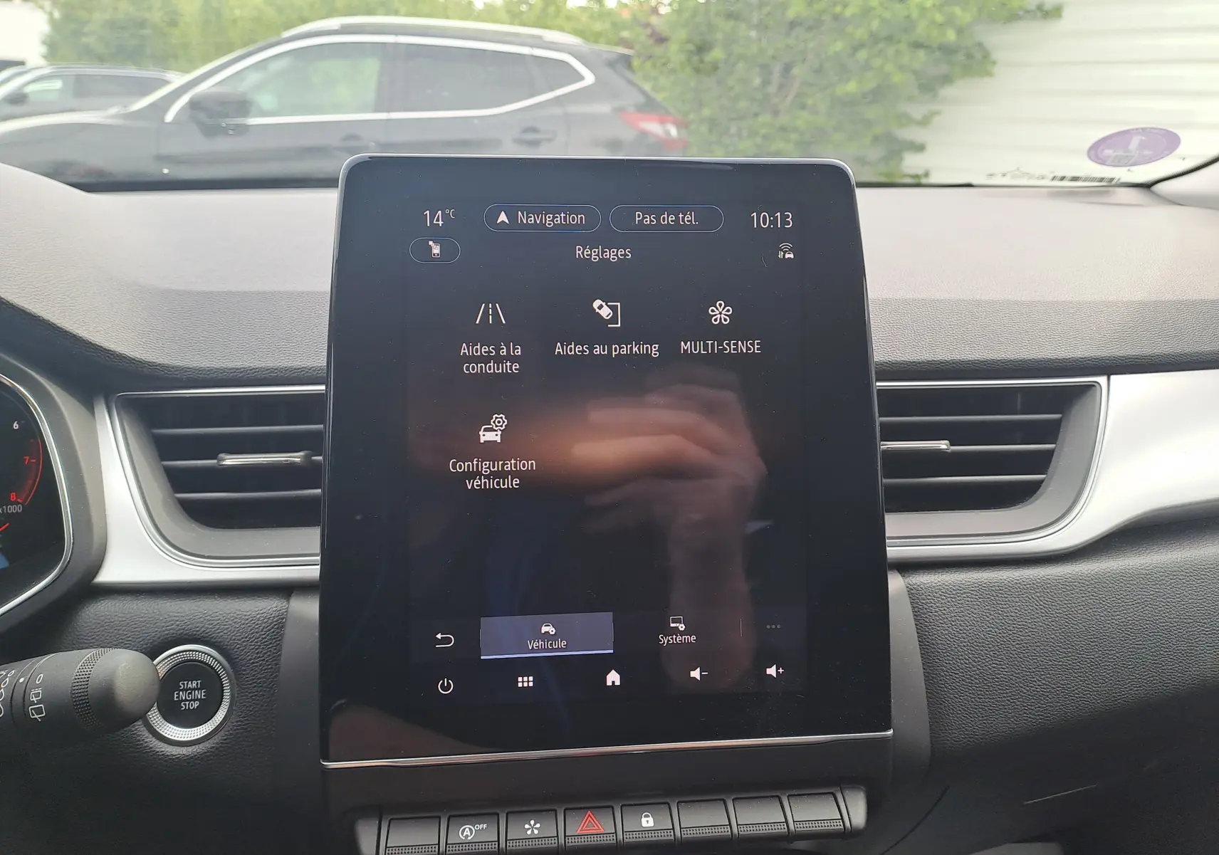 Vue intérieure centrée sur l'écran tactile du tableau de bord du Renault Captur 2022, avec commandes visibles et démarrage sans clé.
