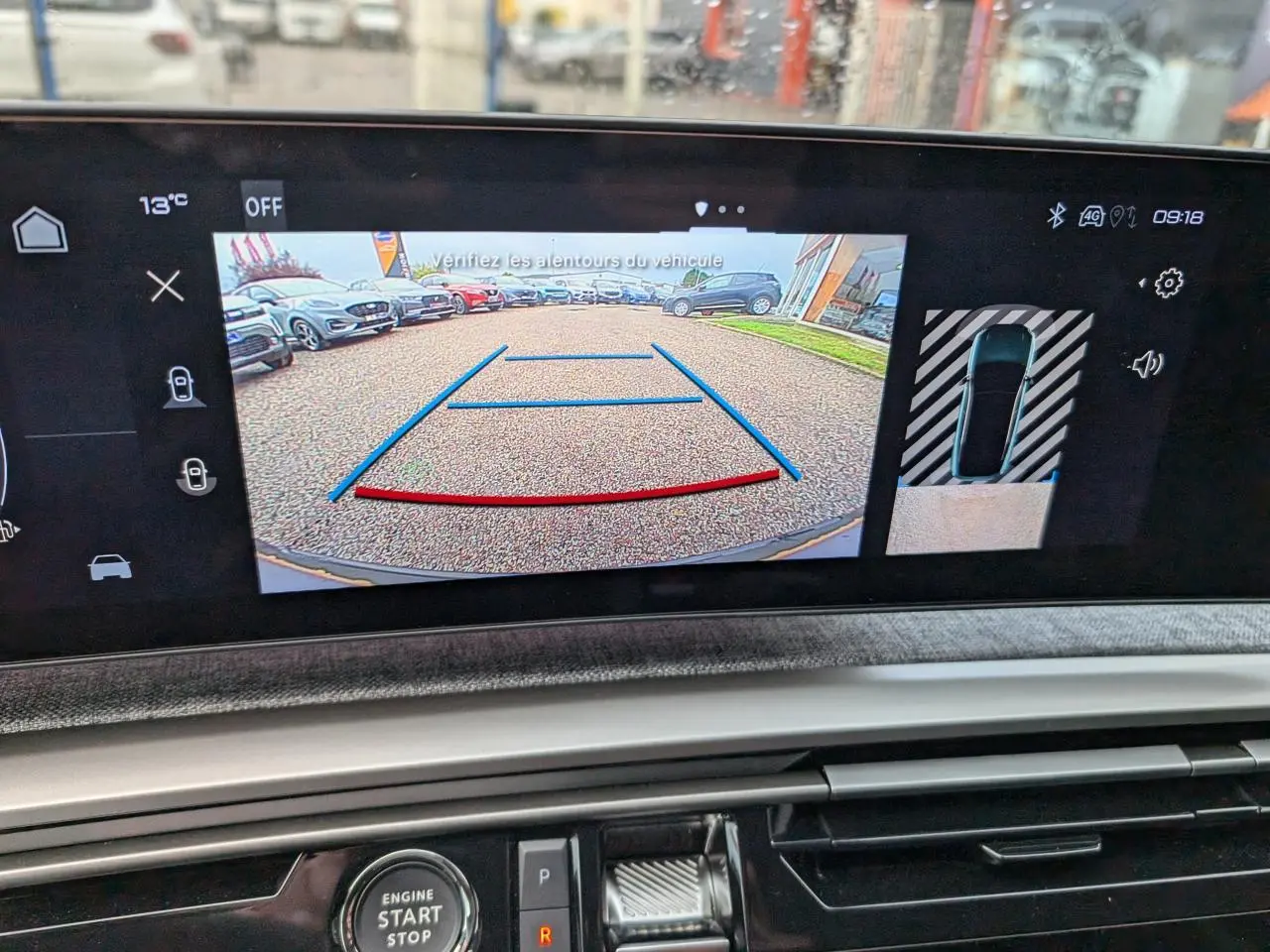 Écran de caméra de recul du Peugeot 3008 bleu métallisé, vue arrière avec lignes de guidage colorées.