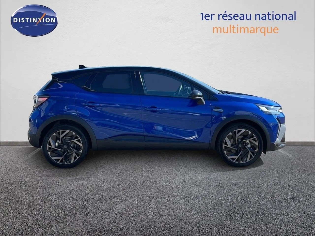 Profil droit du Renault Captur E-Tech hybride 2025 en bleu Iron Metal avec toit noir et jantes alliage.