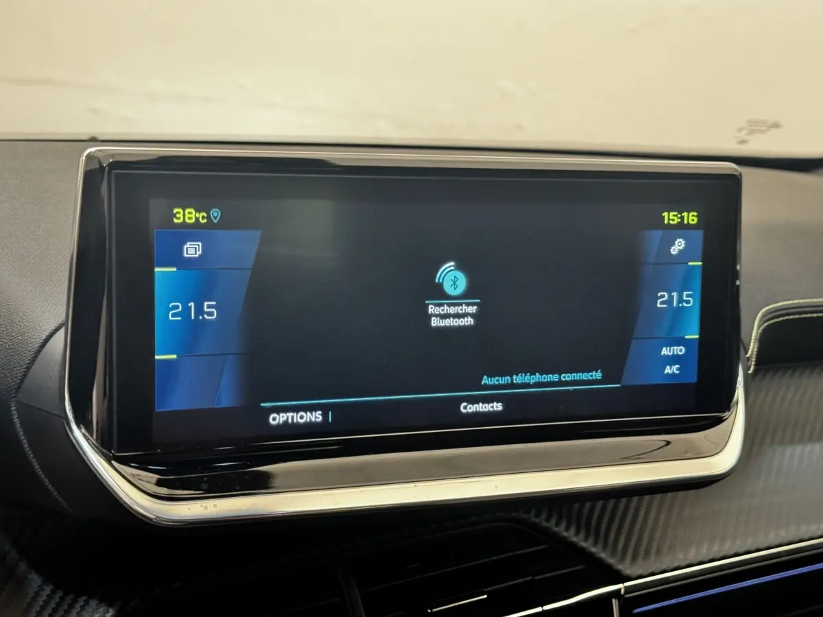 Écran tactile central du tableau de bord du Peugeot E-2008 électrique GT Pack, affichage Bluetooth et climatisation.