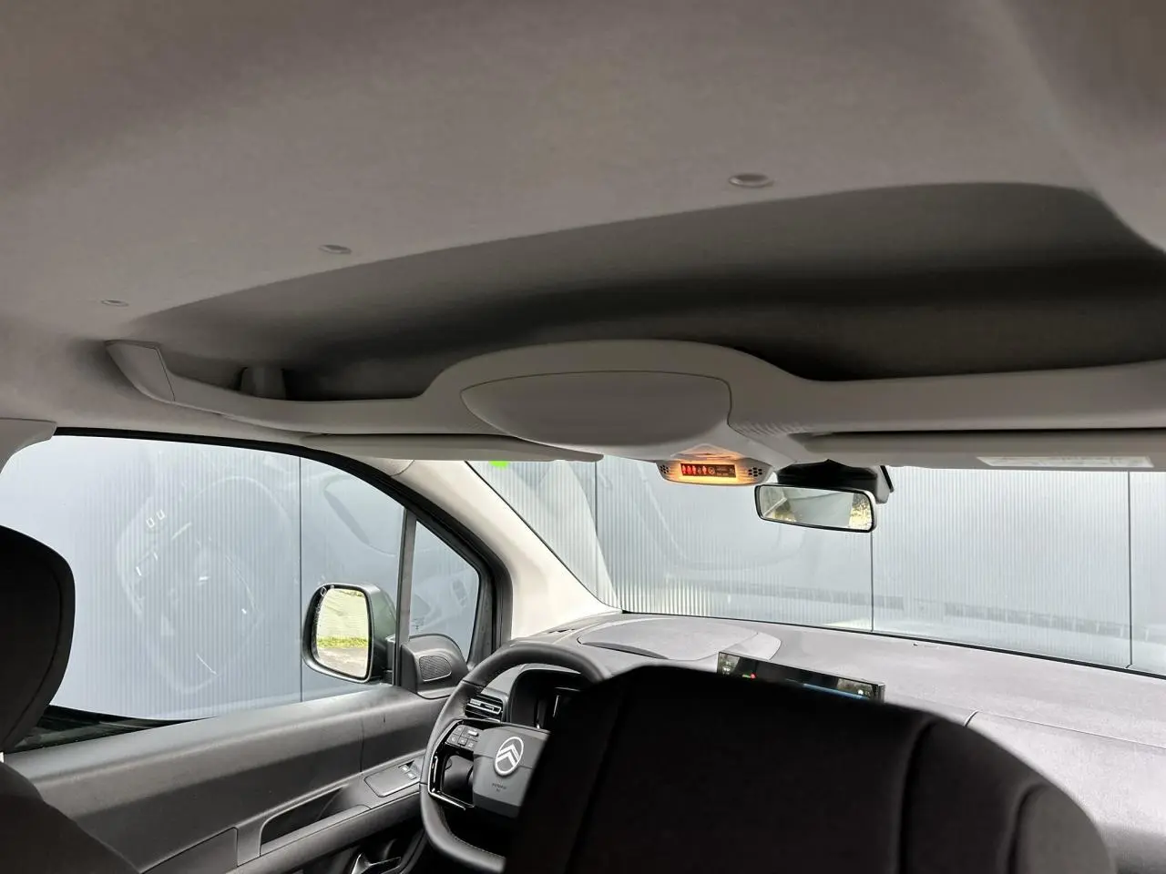 Vue intérieure avant du Citroën Berlingo Multispace noir Perla, volant multifonctions et tableau de bord moderne visibles.