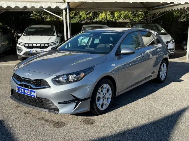 KIA CEE'D argent lunaire vue 3/4 avant droit, avec calandre noire et jantes alliage visibles en plein jour.