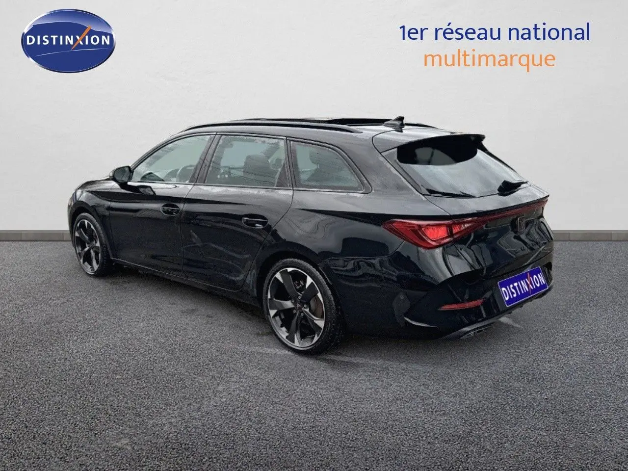 Vue 3/4 arrière droite d'une CUPRA LEON ST noire Midnight Metal avec jantes bi-ton et toit ouvrant panoramique.