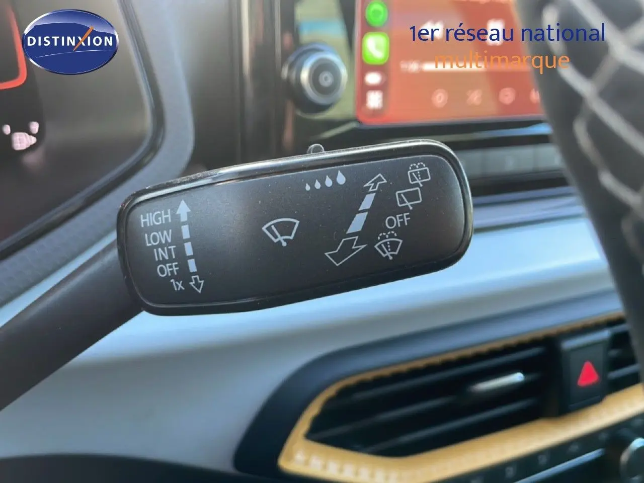 Gros plan sur la commande d’essuie-glace à gauche du volant dans l’habitacle gris clair du SEAT Arona 2025.