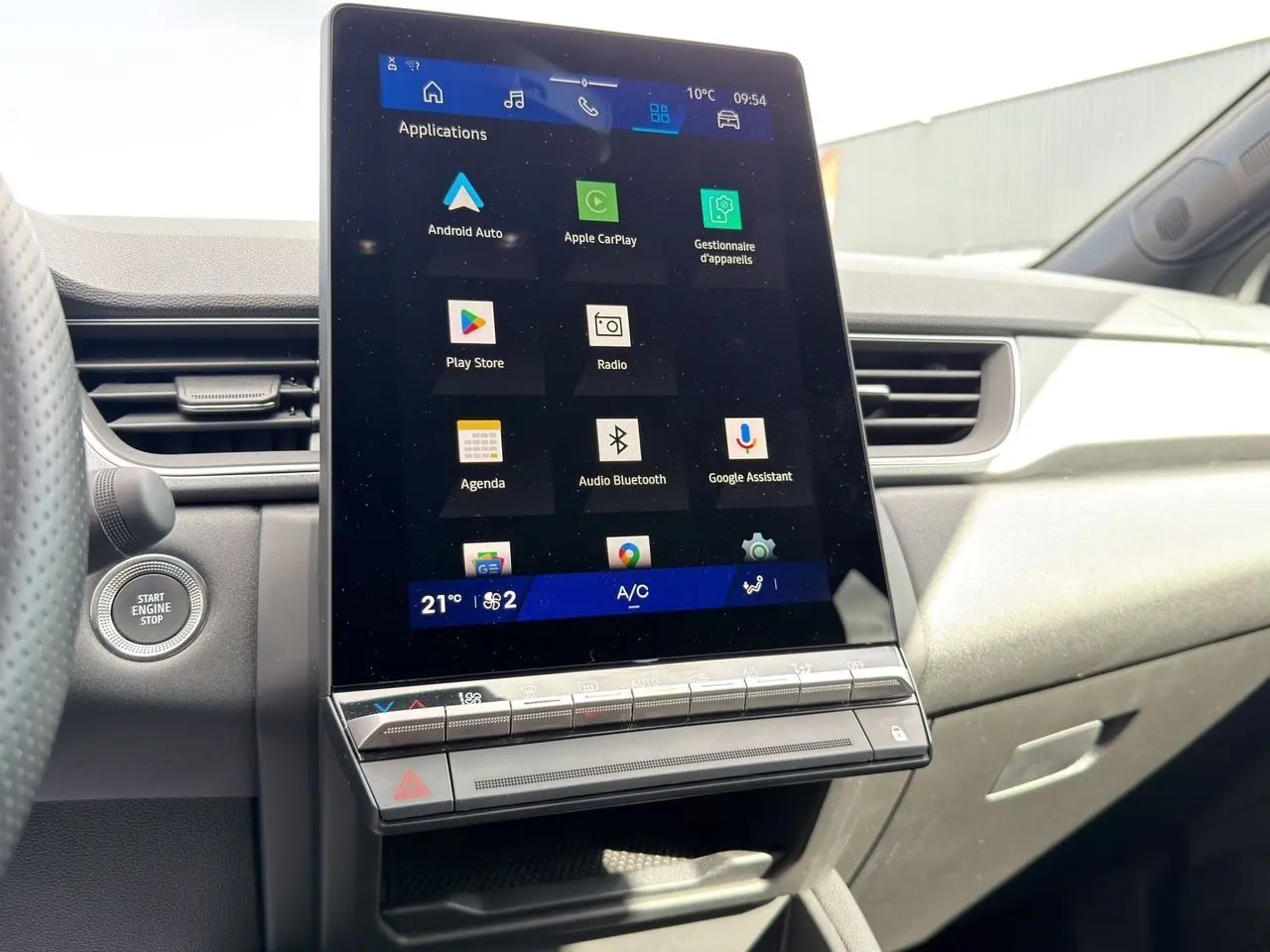 Écran tactile central de 26,4 cm du Renault Symbioz gris clair, vue intérieure côté passager avec bouton démarrage visible.