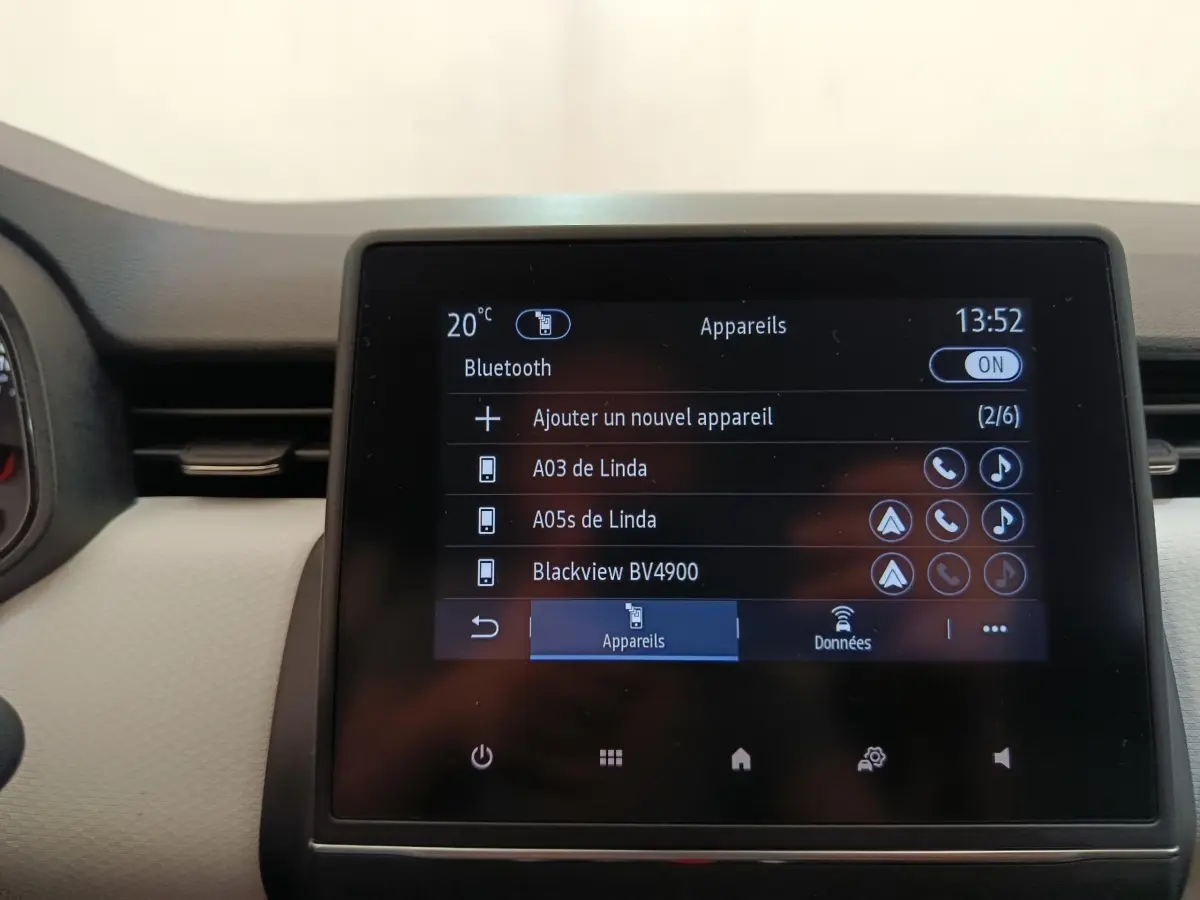 Écran tactile central de la Renault Clio blanc montrant la connexion Bluetooth et la liste des appareils associés.