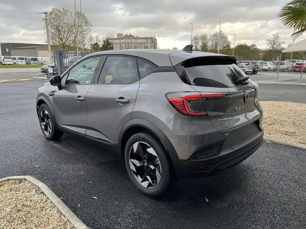 Vue 3/4 arrière droite du Renault Captur gris Cassiopée 2025 avec jantes noires et feux LED distinctifs.