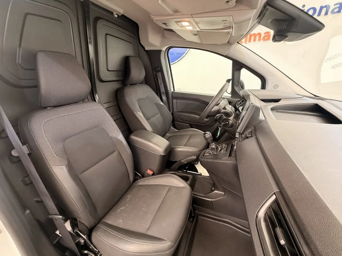 Vue intérieure côté conducteur du Renault Kangoo GD Confort 2023 avec sièges noirs et tableau de bord moderne.