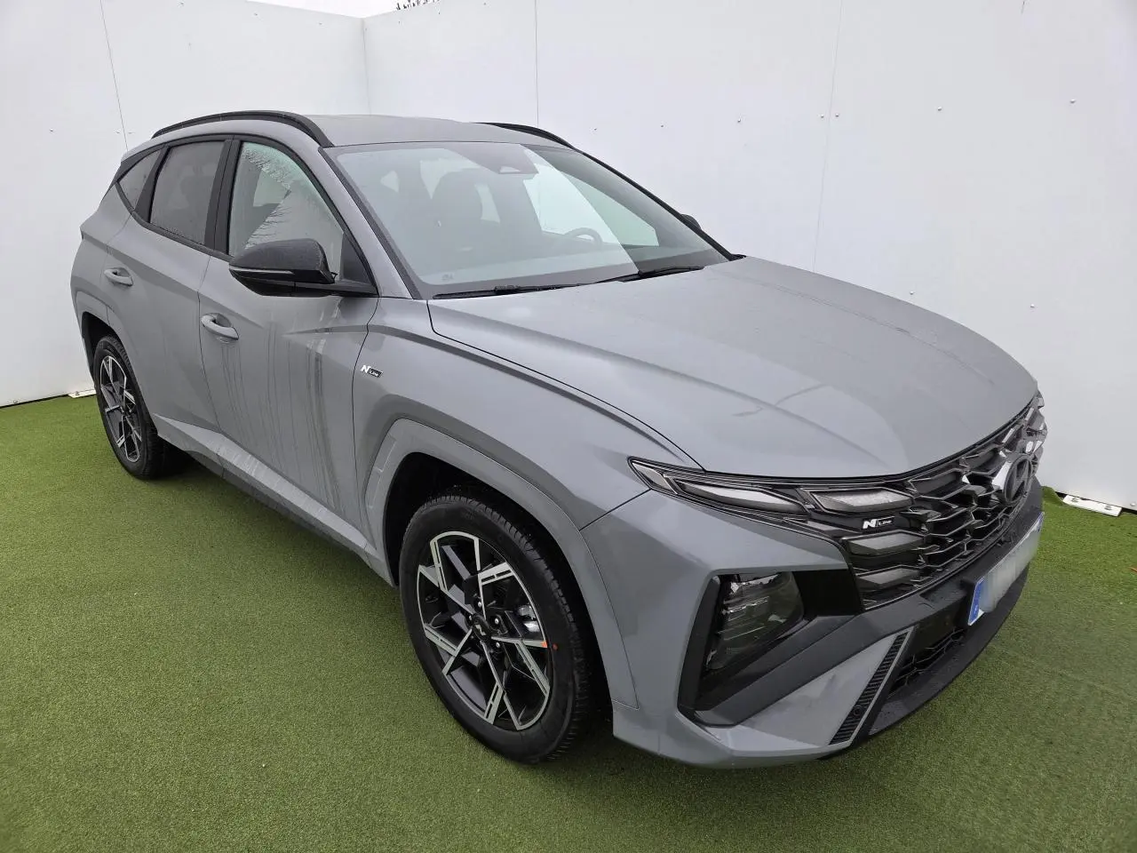Hyundai Tucson 2025 gris Shadow Grey, vue 3/4 avant droit, calandre N Line et jantes alliage 19 pouces.