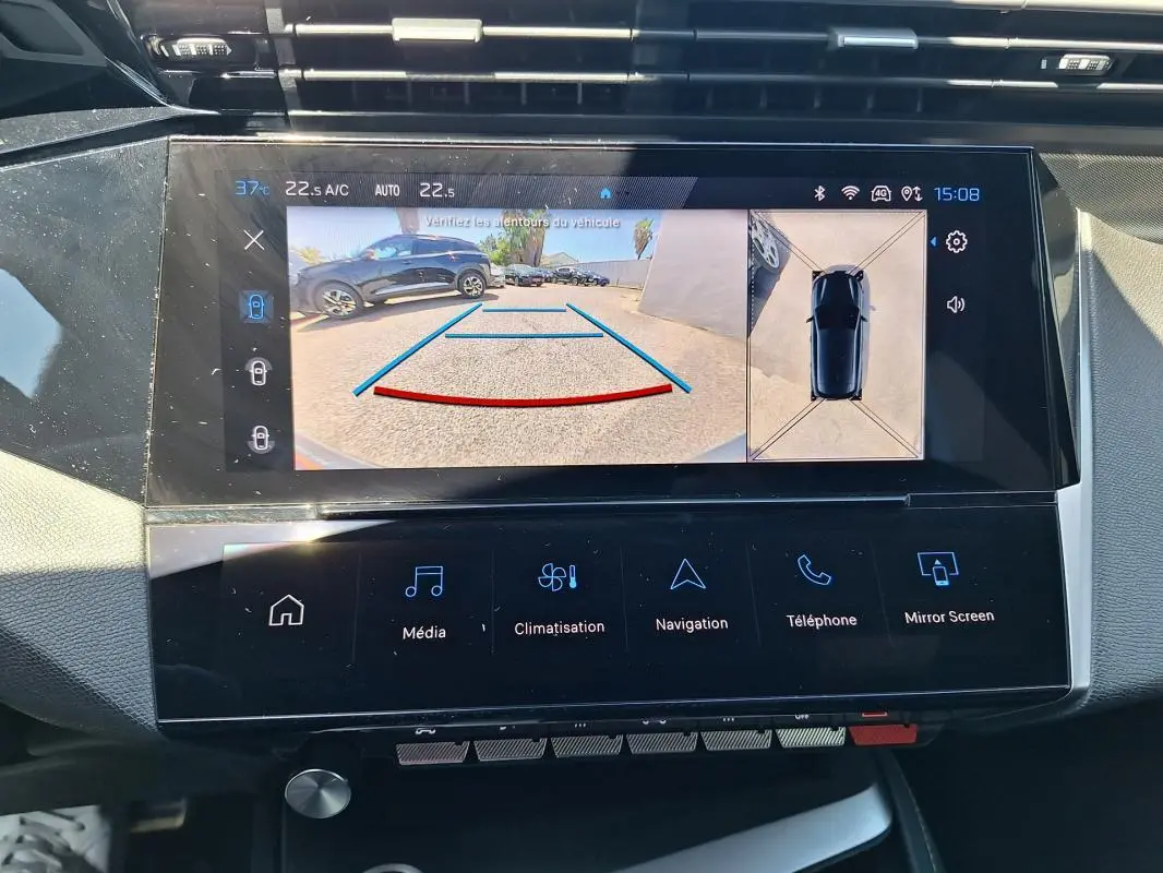 Vue rapprochée de l’écran tactile intérieur du Peugeot 308 Hybrid 145 e-DCS6 GT noir avec caméra de recul affichée.