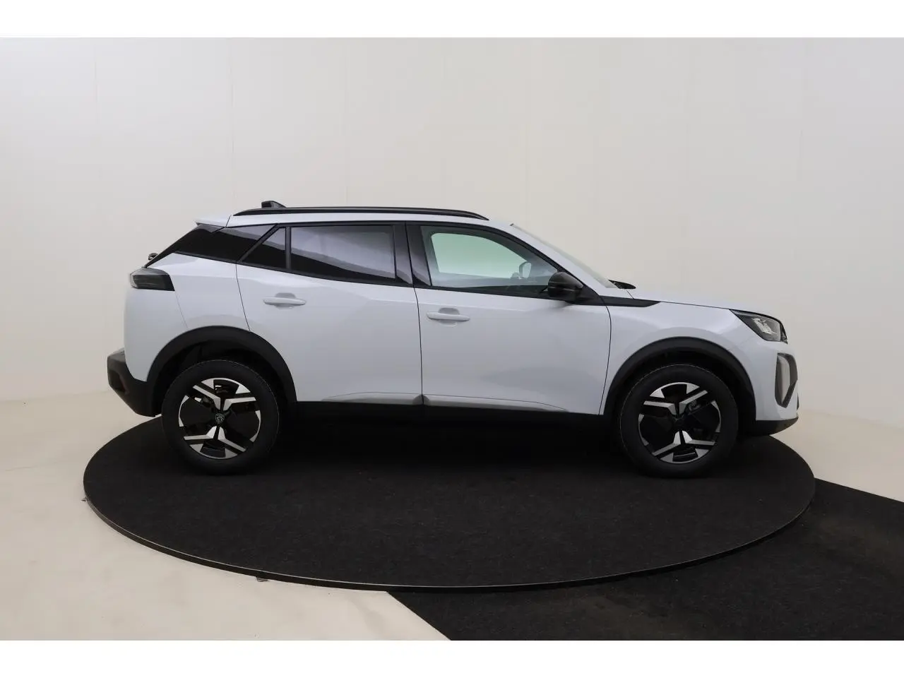 Peugeot 2008 blanc Okenite vue de profil côté gauche, avec barres de toit noires et jantes stylisées.