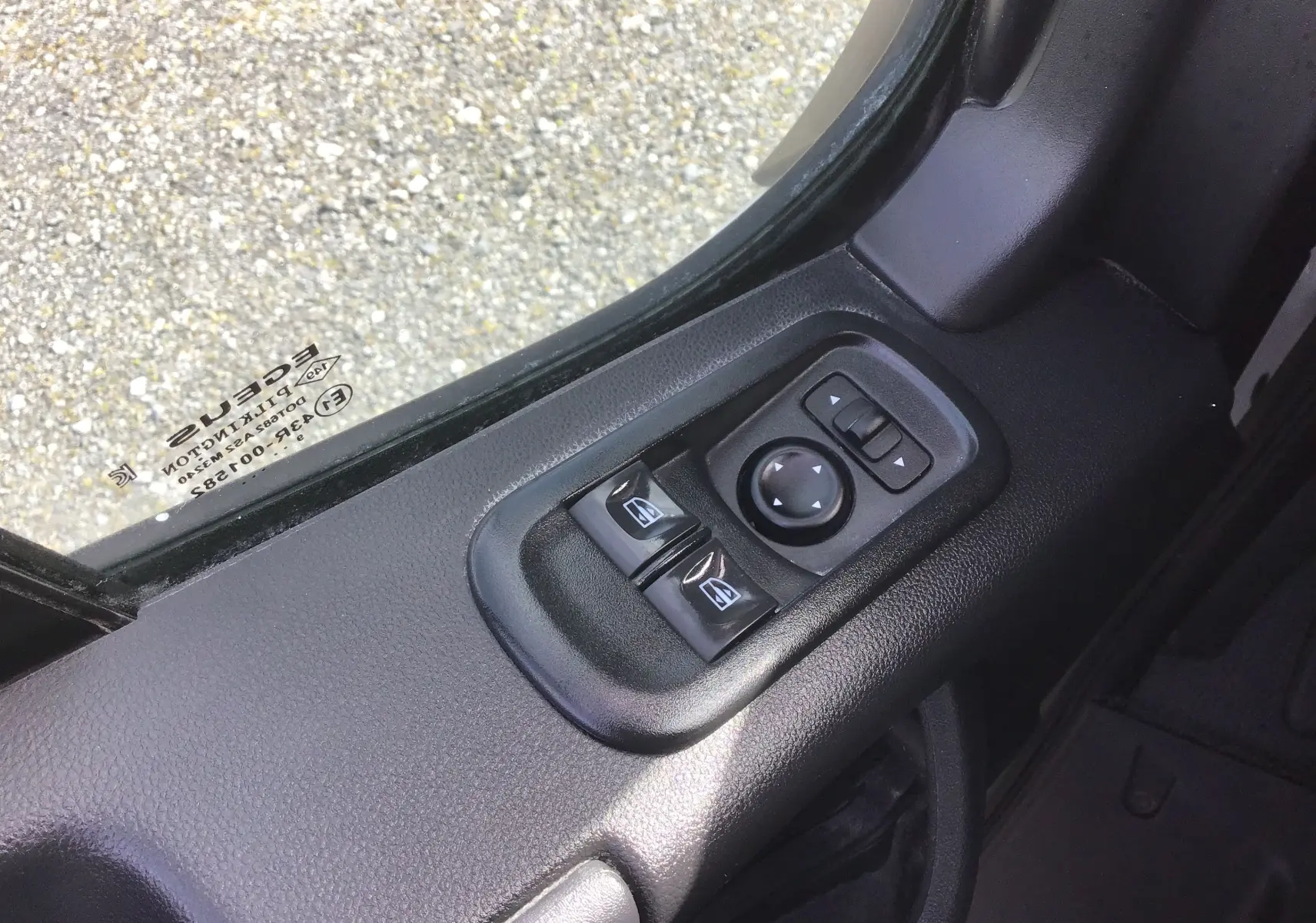 Gros plan sur les commandes électriques des vitres et rétroviseurs côté gauche d’un Renault Master Châssis Cabine blanc.