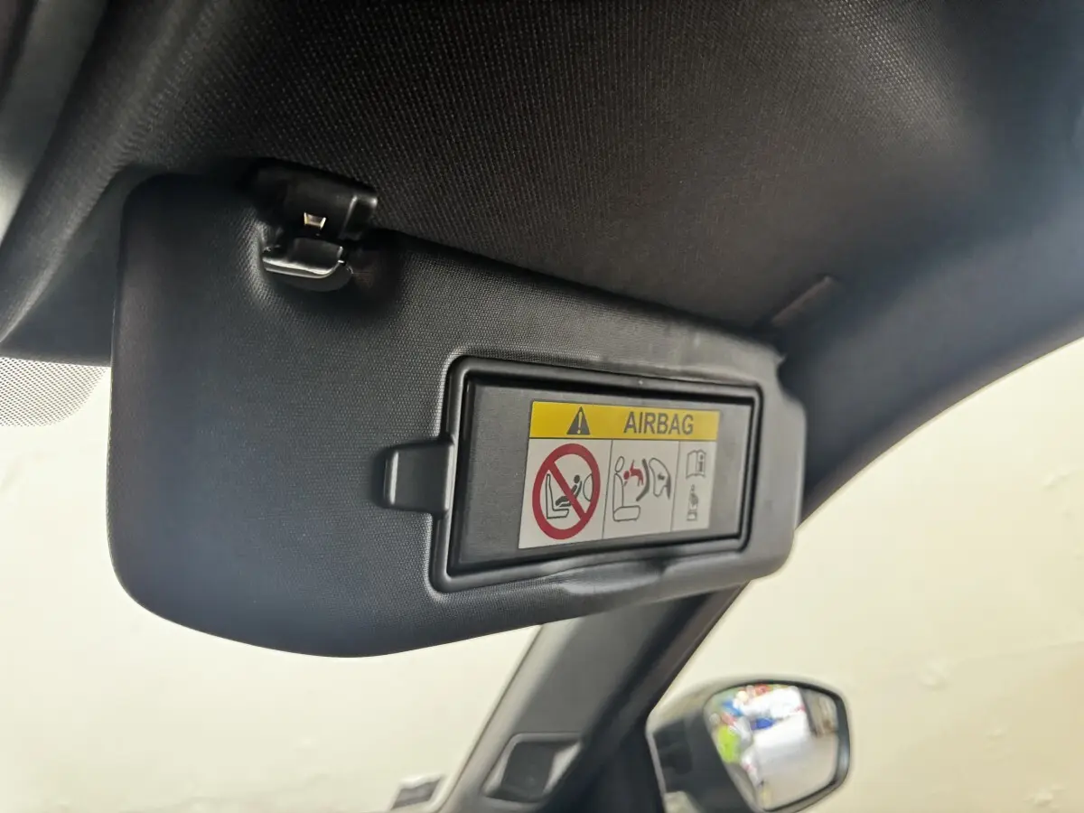 Détail du pare-soleil côté conducteur du DS3 Crossback gris foncé avec avertissement airbag visible.
