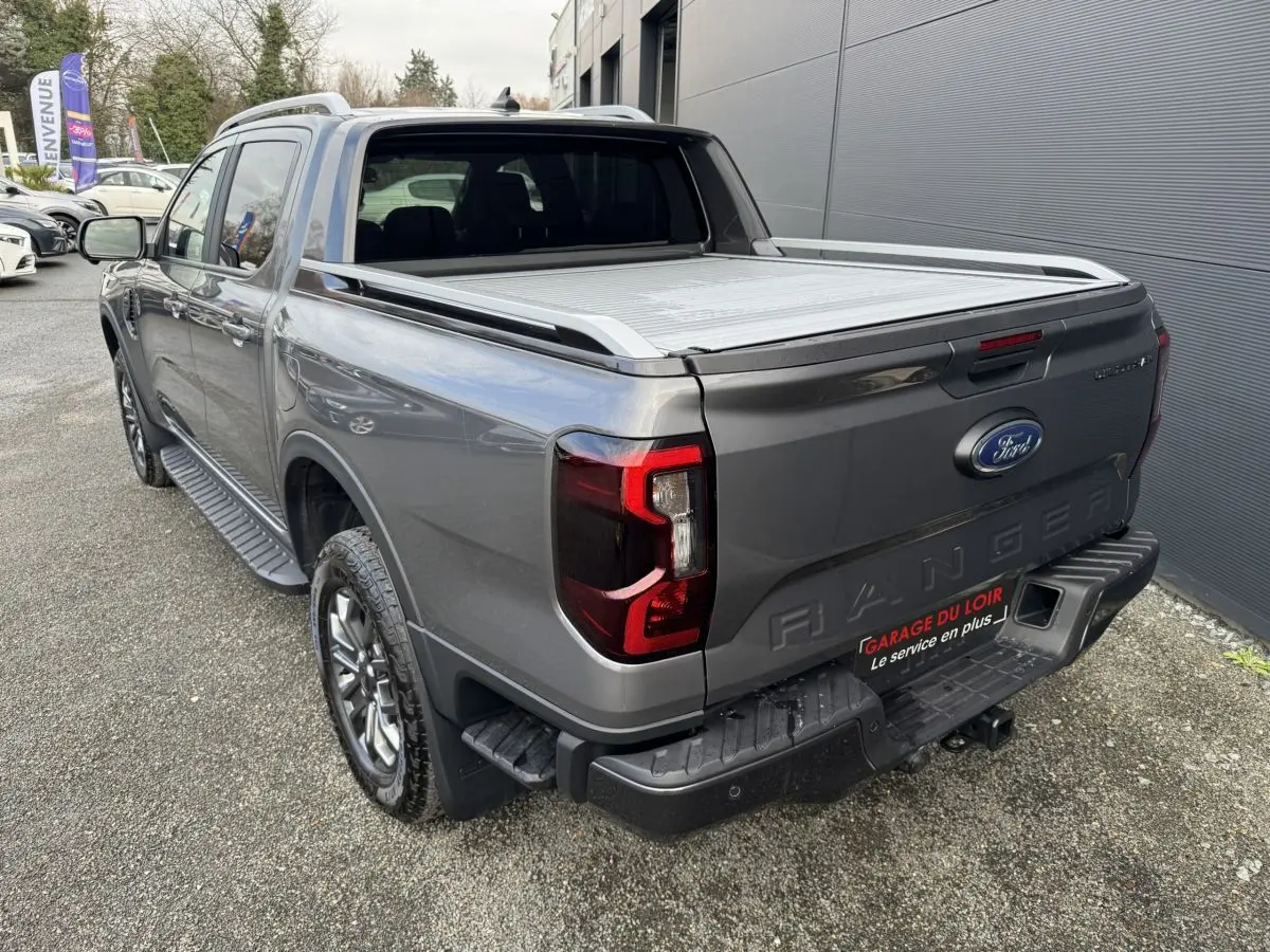 Vue 3/4 arrière droite du Ford Ranger gris avec benne couverte et feux arrière LED distinctifs.