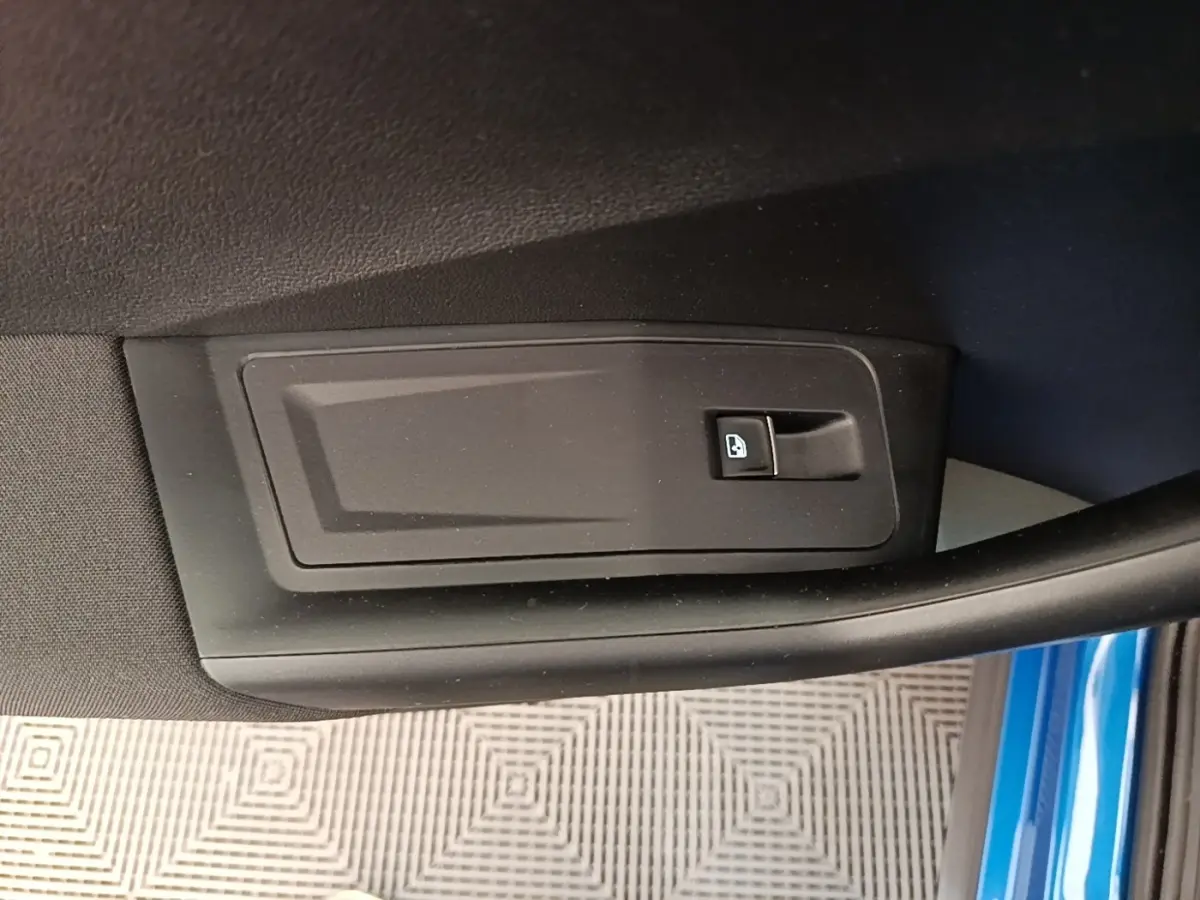 Détail de la poignée intérieure de porte côté conducteur d’un Volkswagen T-Roc bleu 2020.