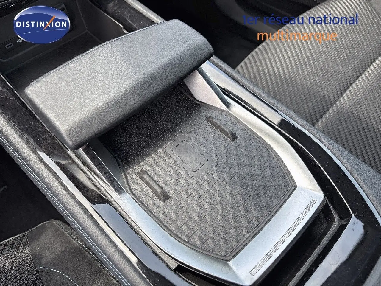 Gros plan sur la console centrale noire et grise avec accoudoir et siège tissu à motifs du Renault Austral 2022.