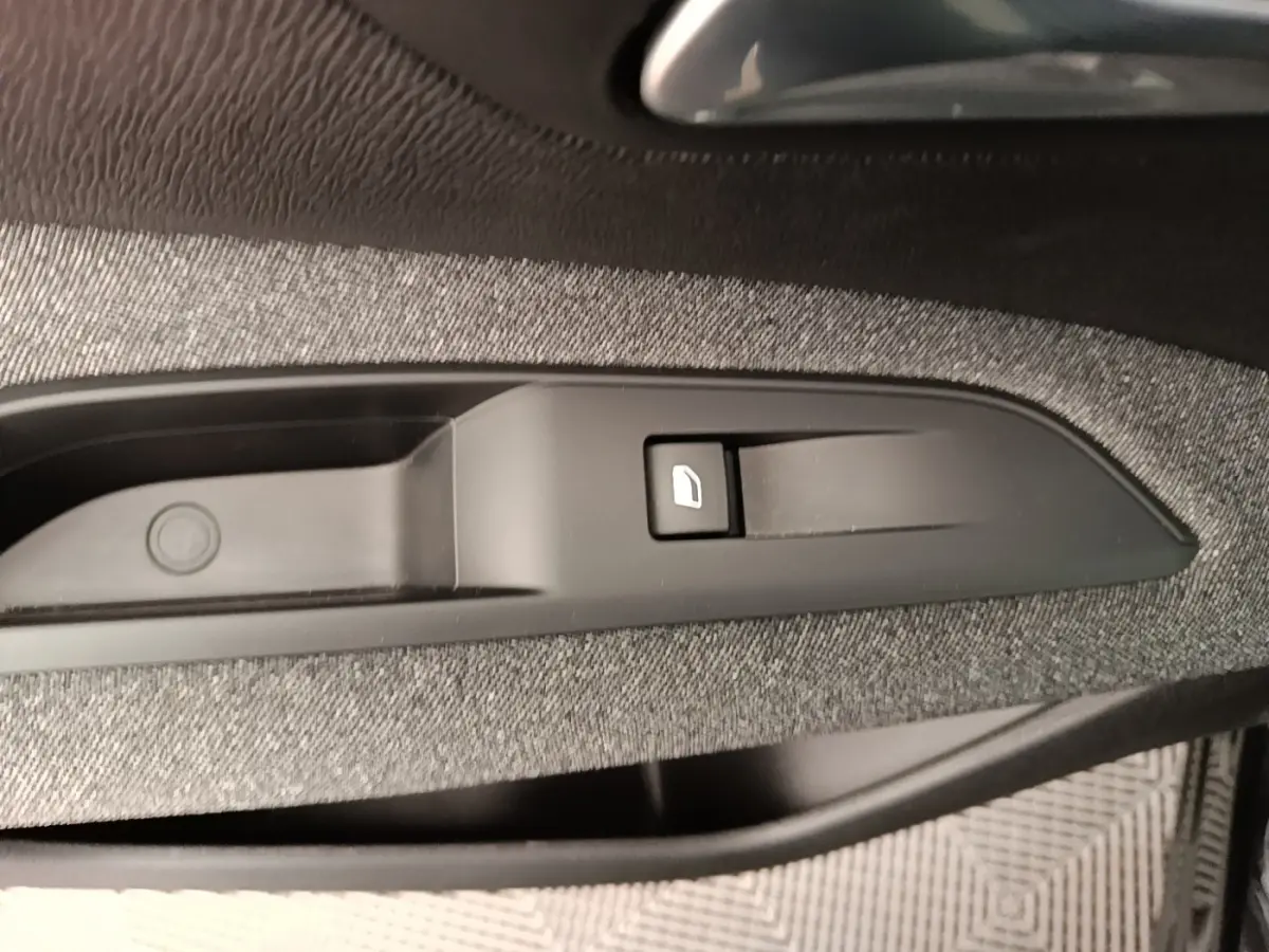 Gros plan sur le bouton de verrouillage des portes côté conducteur, garniture tissu gris foncé Peugeot 3008 noir.